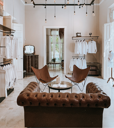Retail sore with brown leather sofa and brown chairs