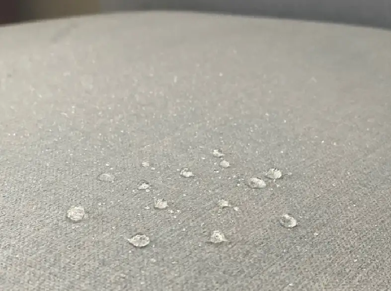 Close up of water molecules on grey upholstery